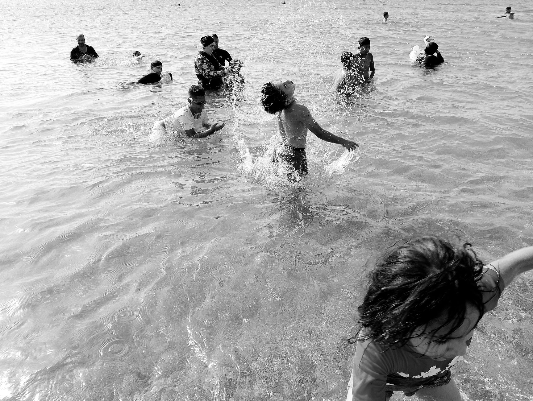 Kids playing joyfully in the water under the sun, capturing summer fun and happiness.