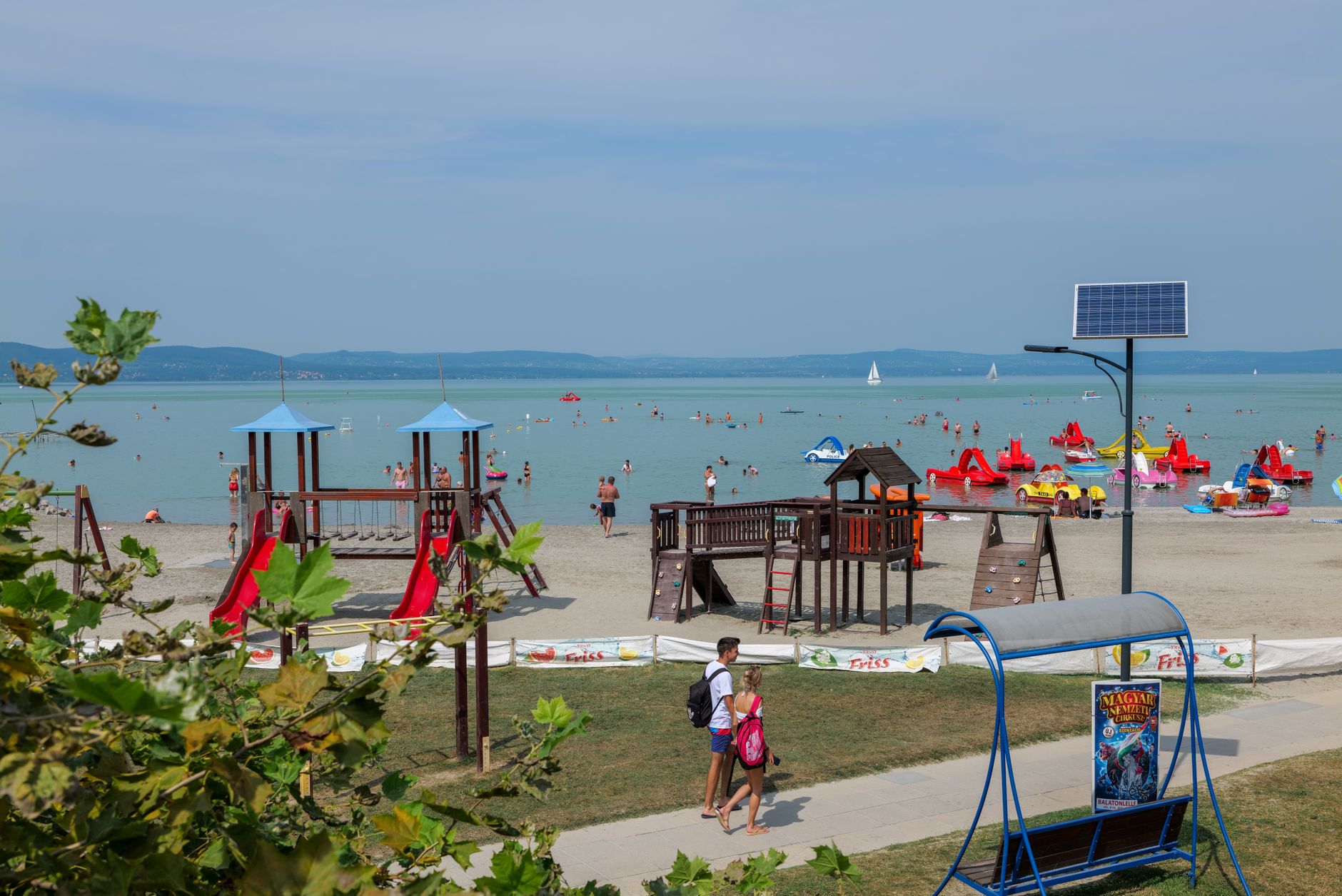 Families enjoying the beach and playground by Lake Balaton in Hungary.