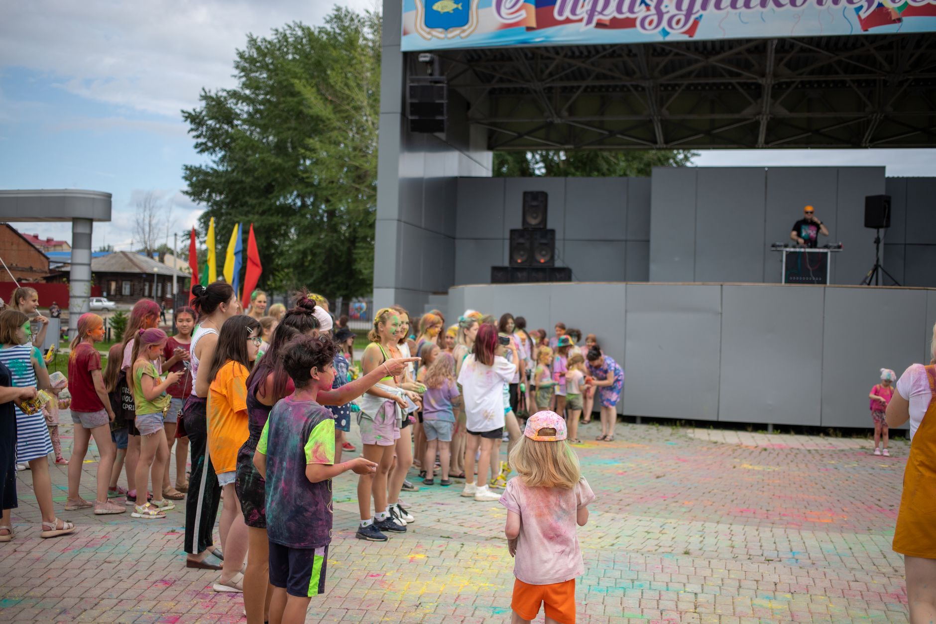 Children at a colorful outdoor festival playing together with vibrant colors and joy.