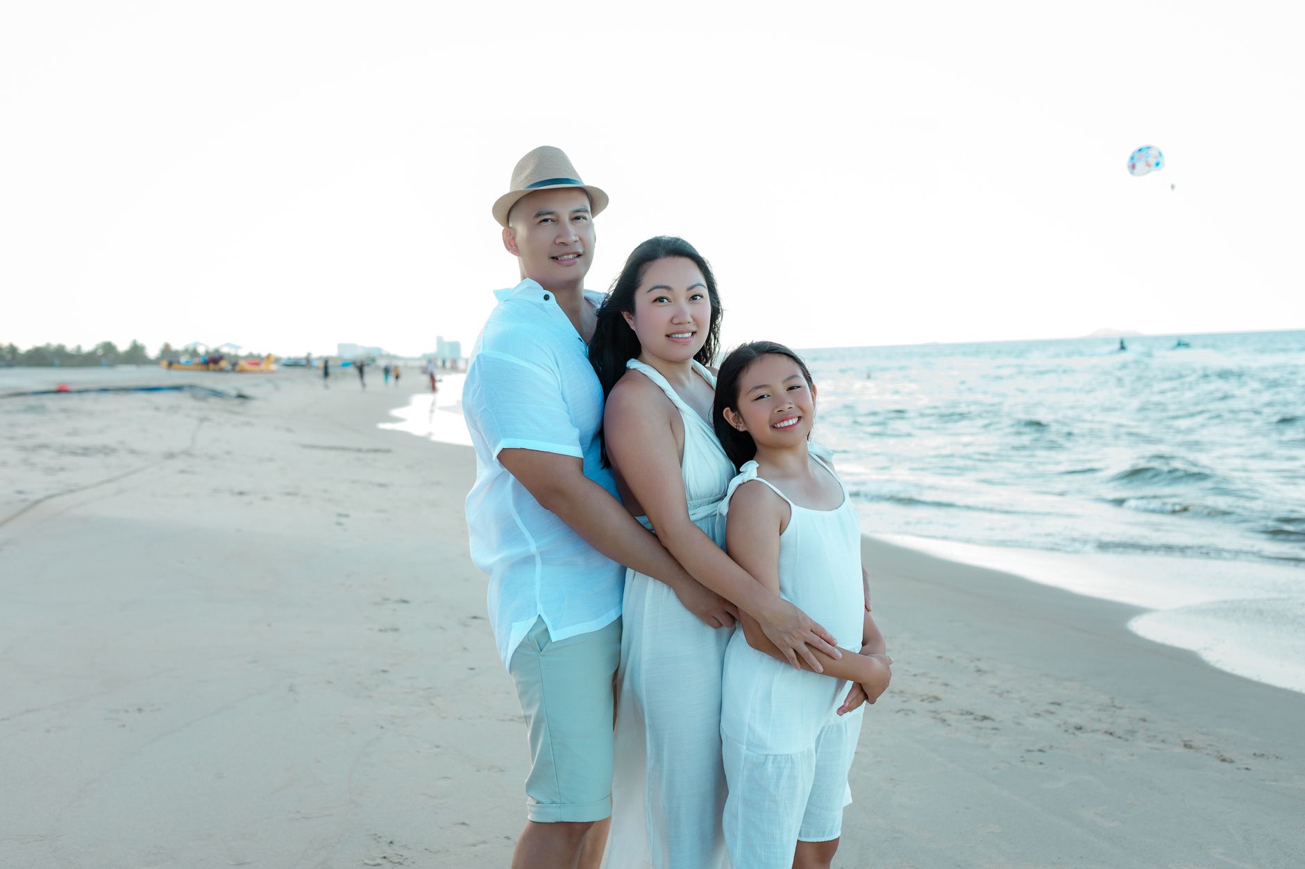 Family enjoying a warm sunset on the picturesque beach in Hoi An, Vietnam. Perfect summer moment.