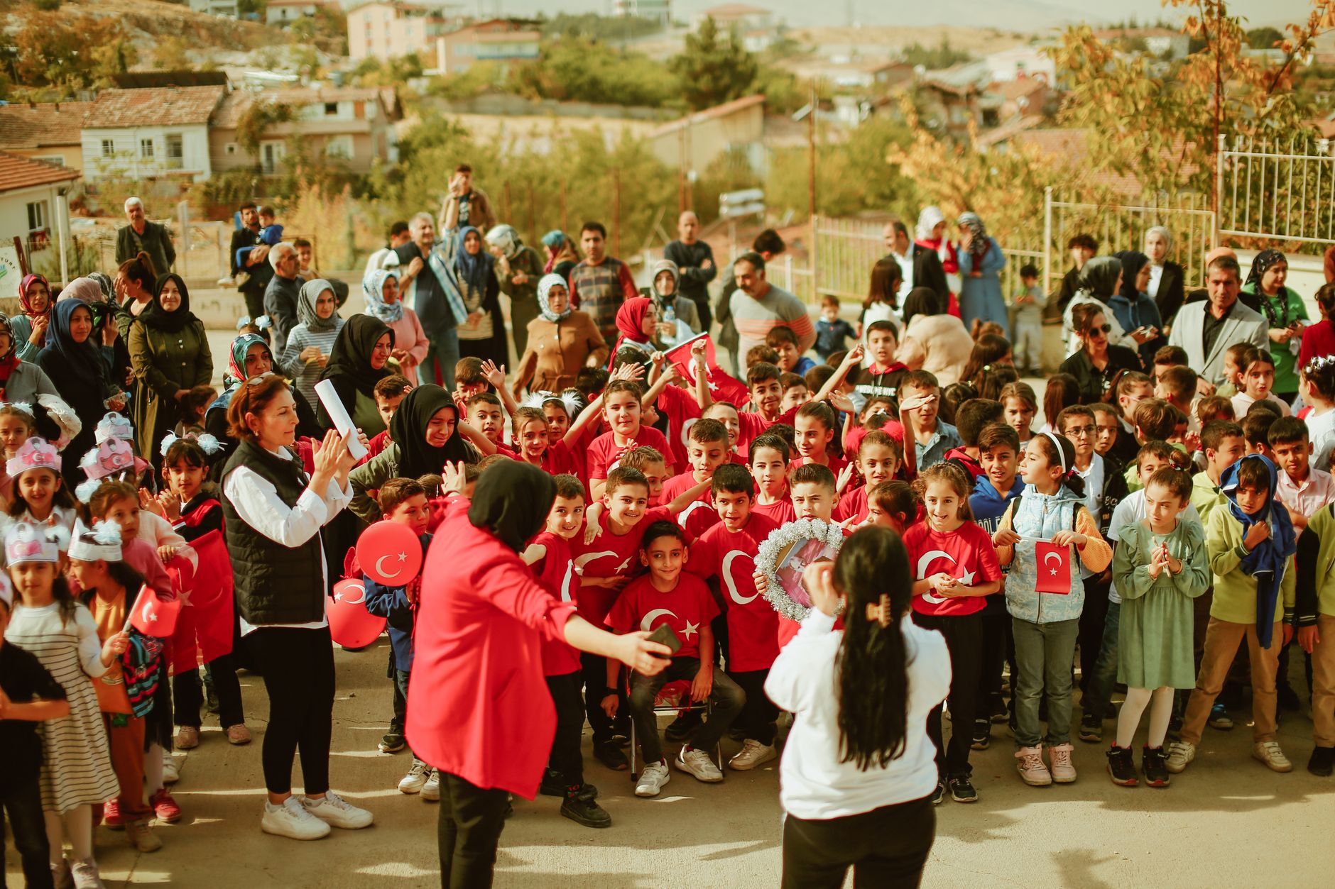 A joyful outdoor celebration with children and adults during daylight.